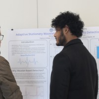A student and faculty member looking at a project.